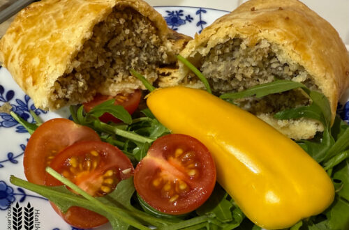 Cumberland sausage roll. Split and served with salad